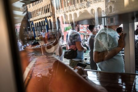 Overtourism in Venice. Photography and video by photographer Marco Panzetti. A scene from a crowded "vaporetto", Venice's water buses. 