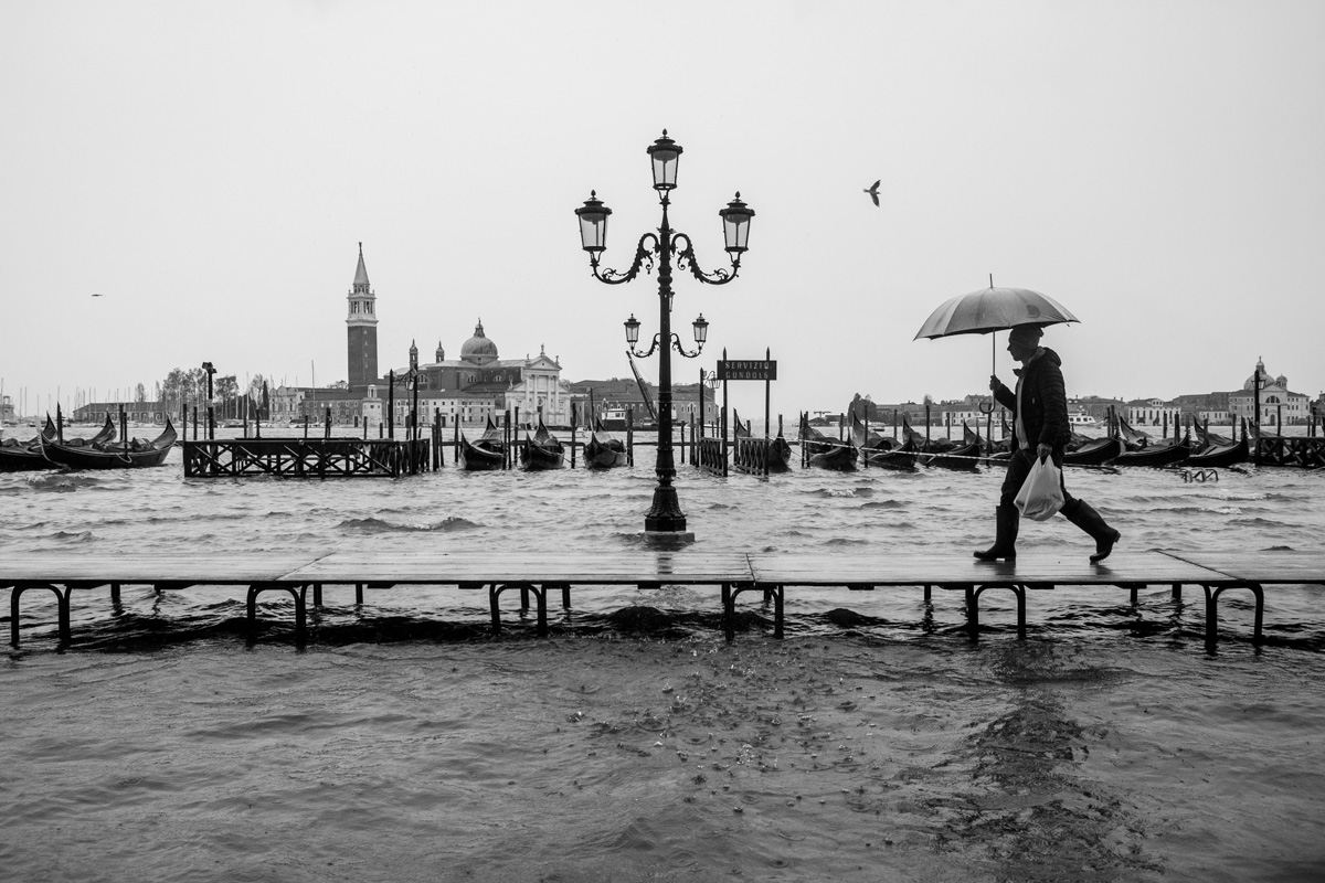 Nov 15th 2019. A flooded St. Mark's Square reflected in the window of an historic cafè, also flooded with water. 
